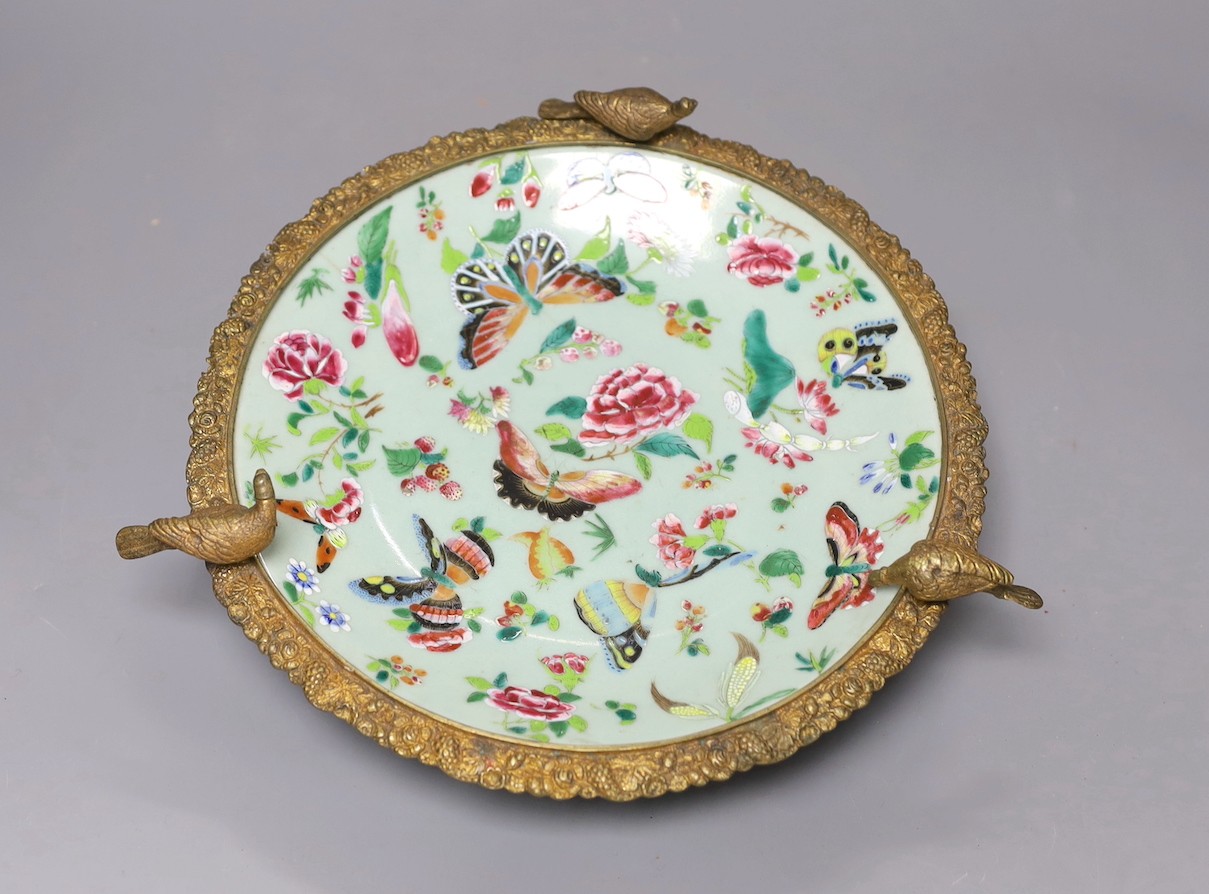 A 19th century Chinese famille rose dish with ormolu mount, 29 cms diameter.